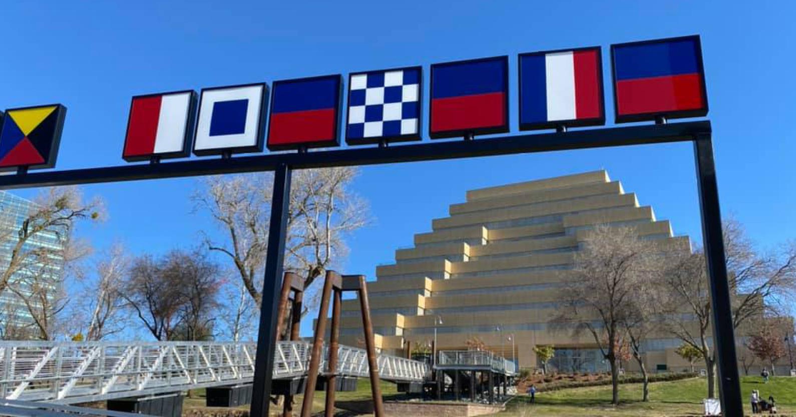 A sculpture of boat signs on the river dock.